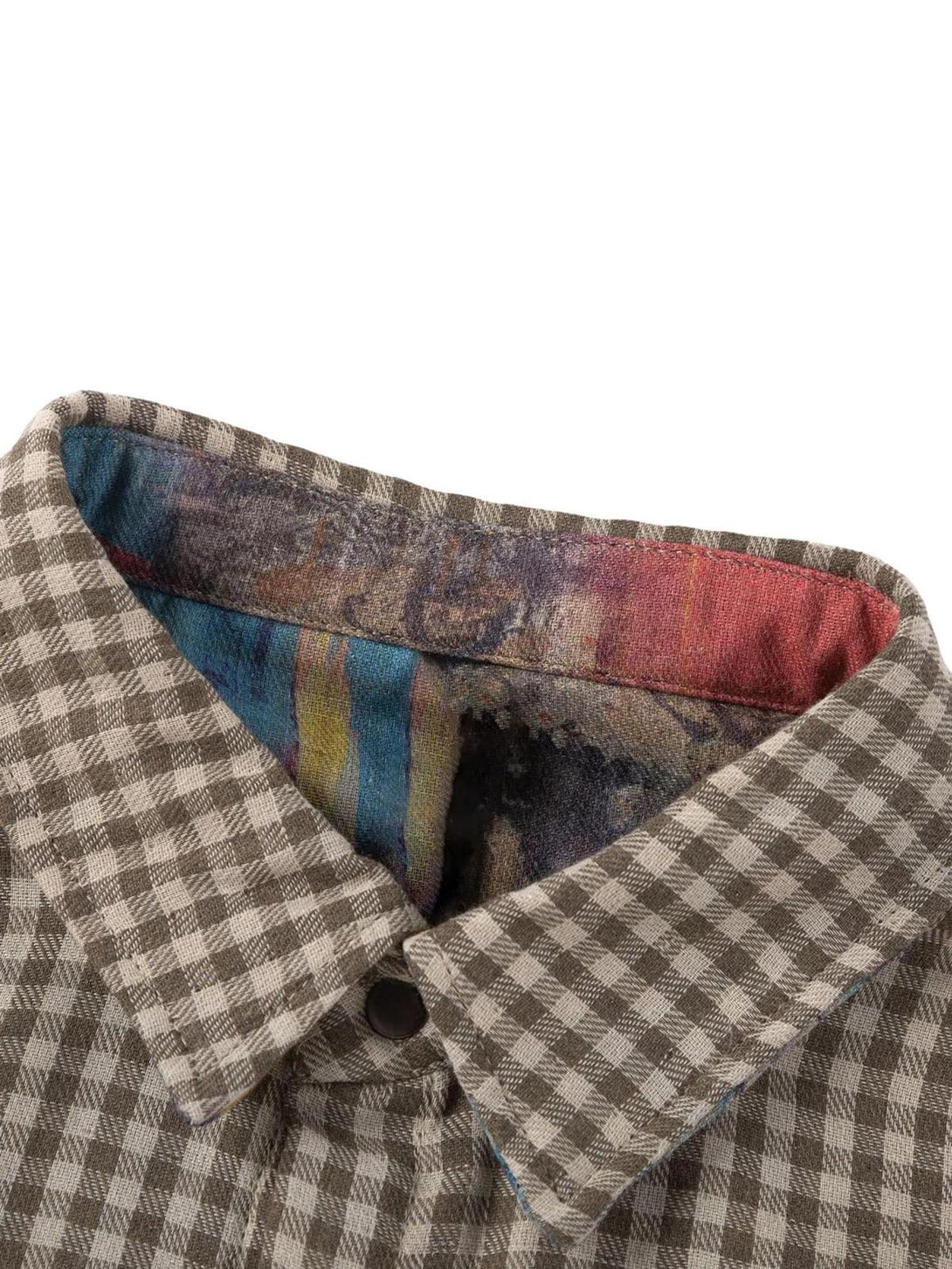 A detailed view of TALISHKO's checkered reversible shirt collar, revealing colorful inner fabric.