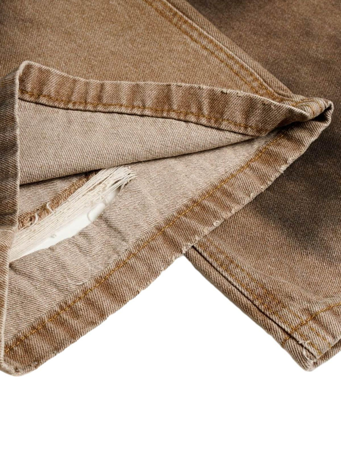 Detailed fabric and stitching of TALISHKO street jeans, highlighting their unique distressed look.