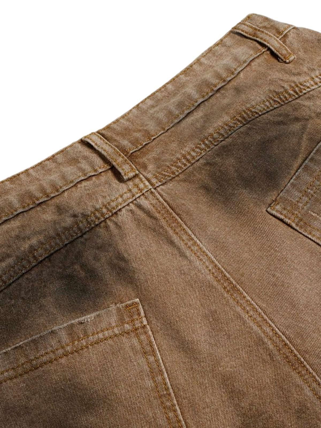 Detailed view of TALISHKO jeans' back, showcasing distressed stitching and faded dye effect.