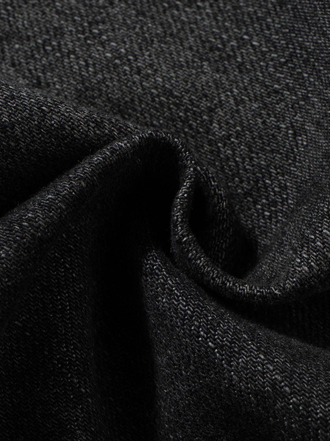 Zoomed-in texture of TALISHKO's black denim cargo jort, showcasing the intricate weave.