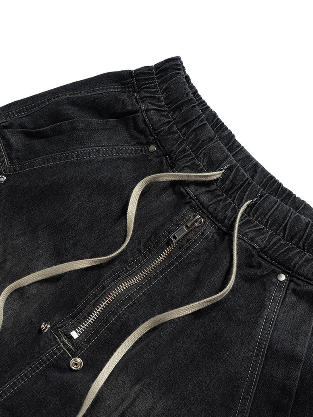 Detailed view of TALISHKO's washed denim cargo jort, highlighting the drawstring and zipper.