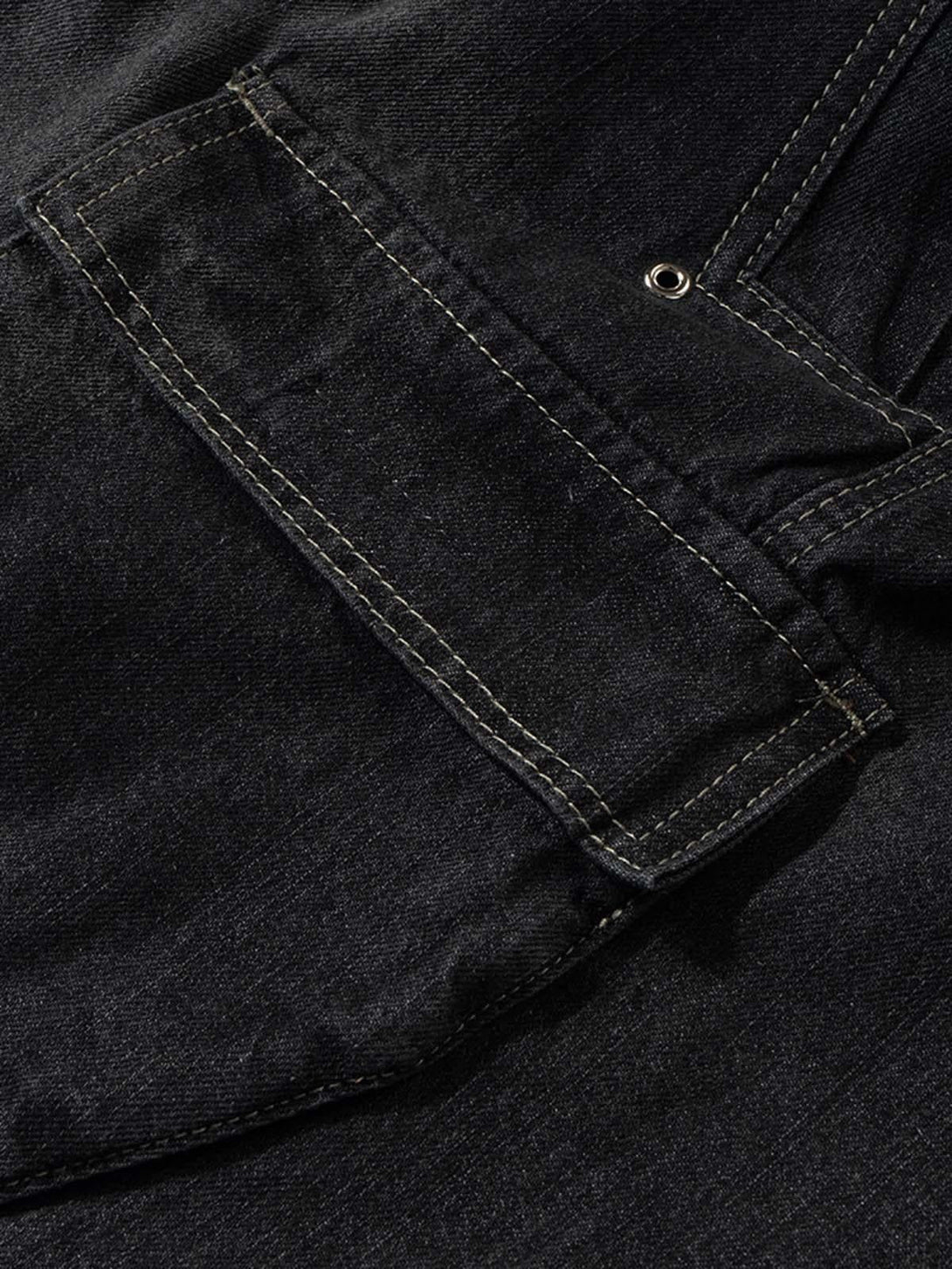 Detailed fabric and stitching on TALISHKO's black denim cargo jort, highlighting pocket design.