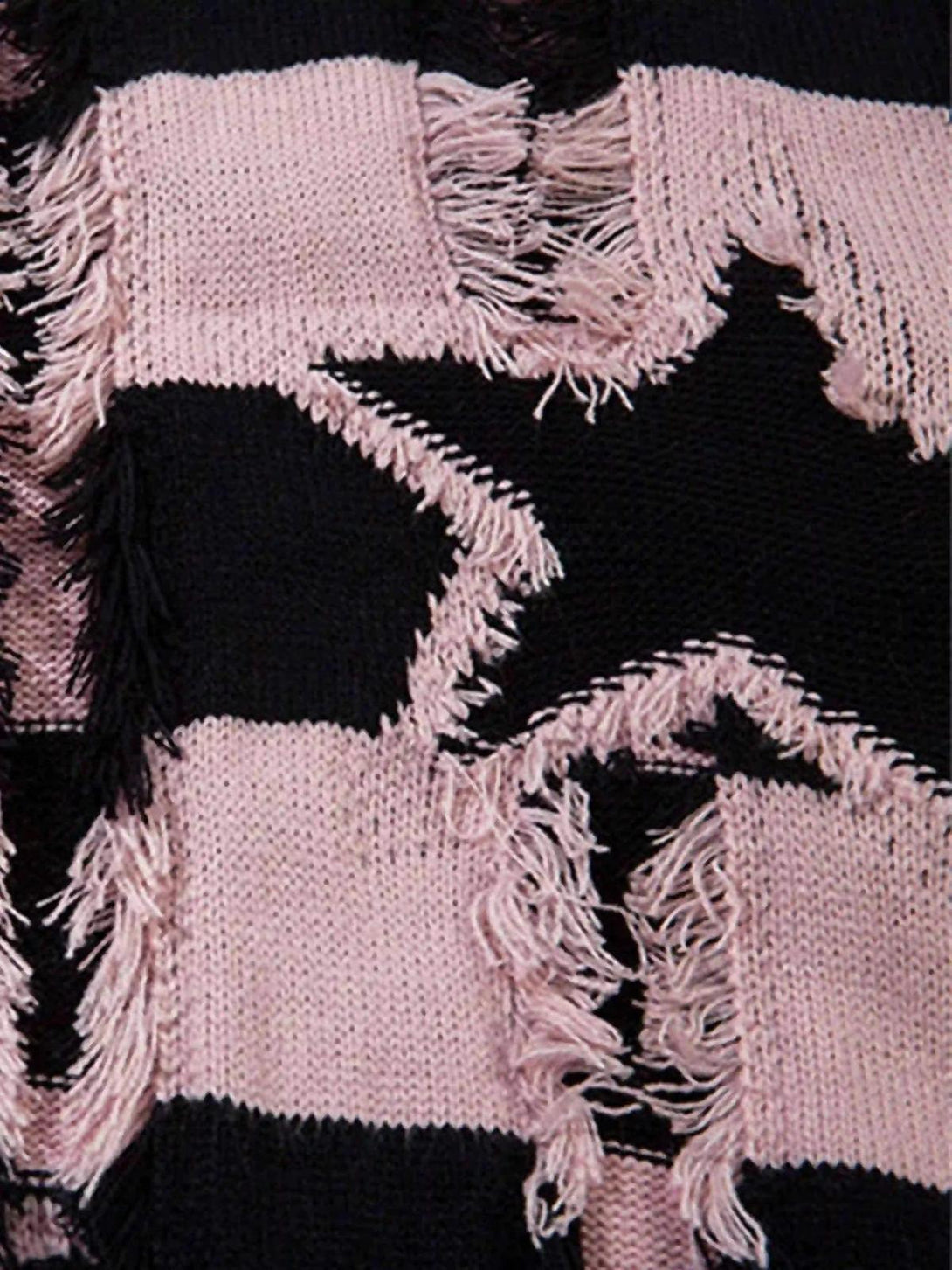 TALISHKO sweater detail with pink and black star stripes, featuring a distressed texture.