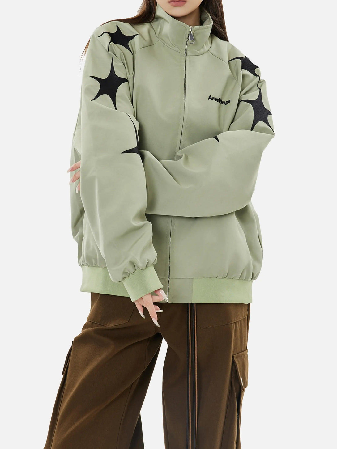 Model in TALISHKO green zip-up jacket with star embroidery, highlighting casual street style.