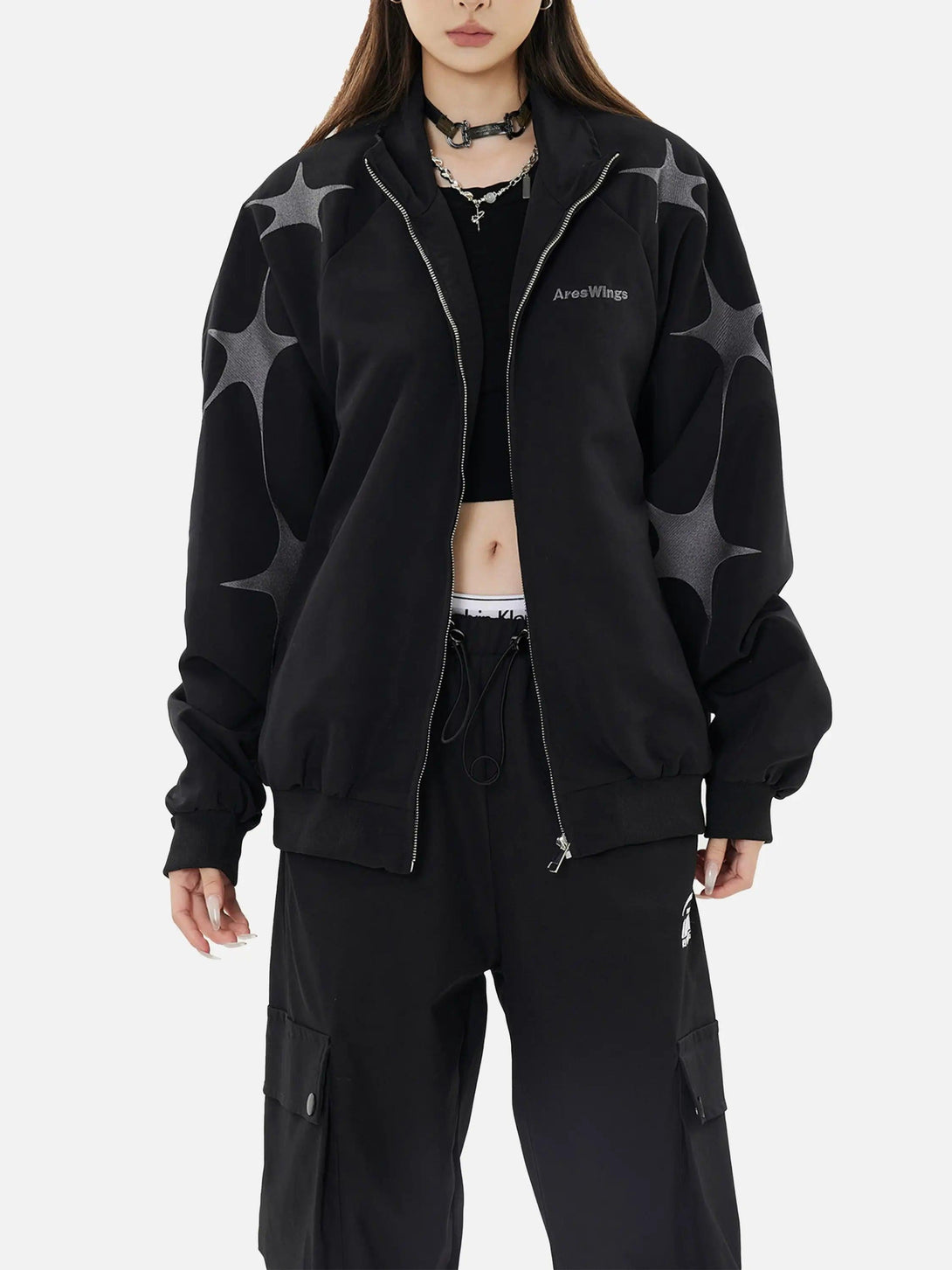 Model wearing TALISHKO's black zip-up jacket with star embroidery, showcasing edgy streetwear style.