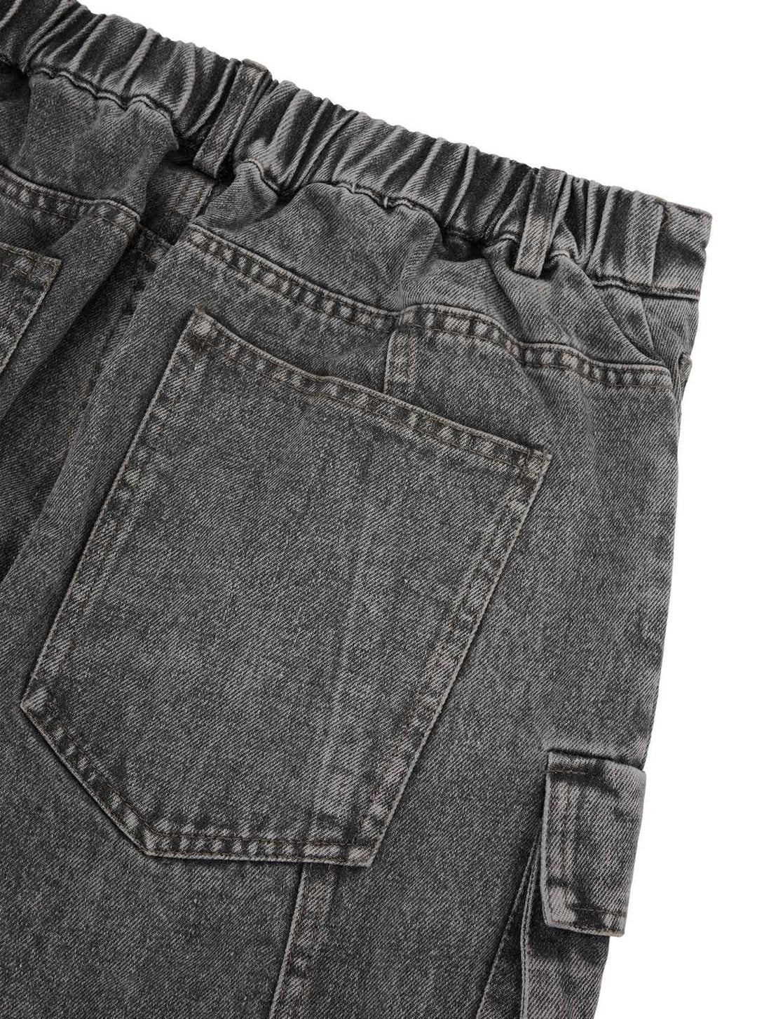 Detailed view of TALISHKO's washed jeans, highlighting the elastic waistband and pocket design.