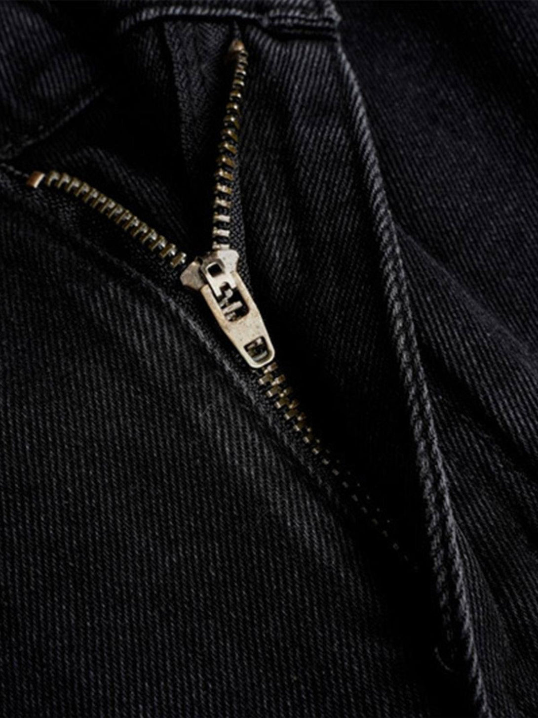 A close-up of TALISHKO work jeans highlighting the sturdy zipper and textured black fabric.