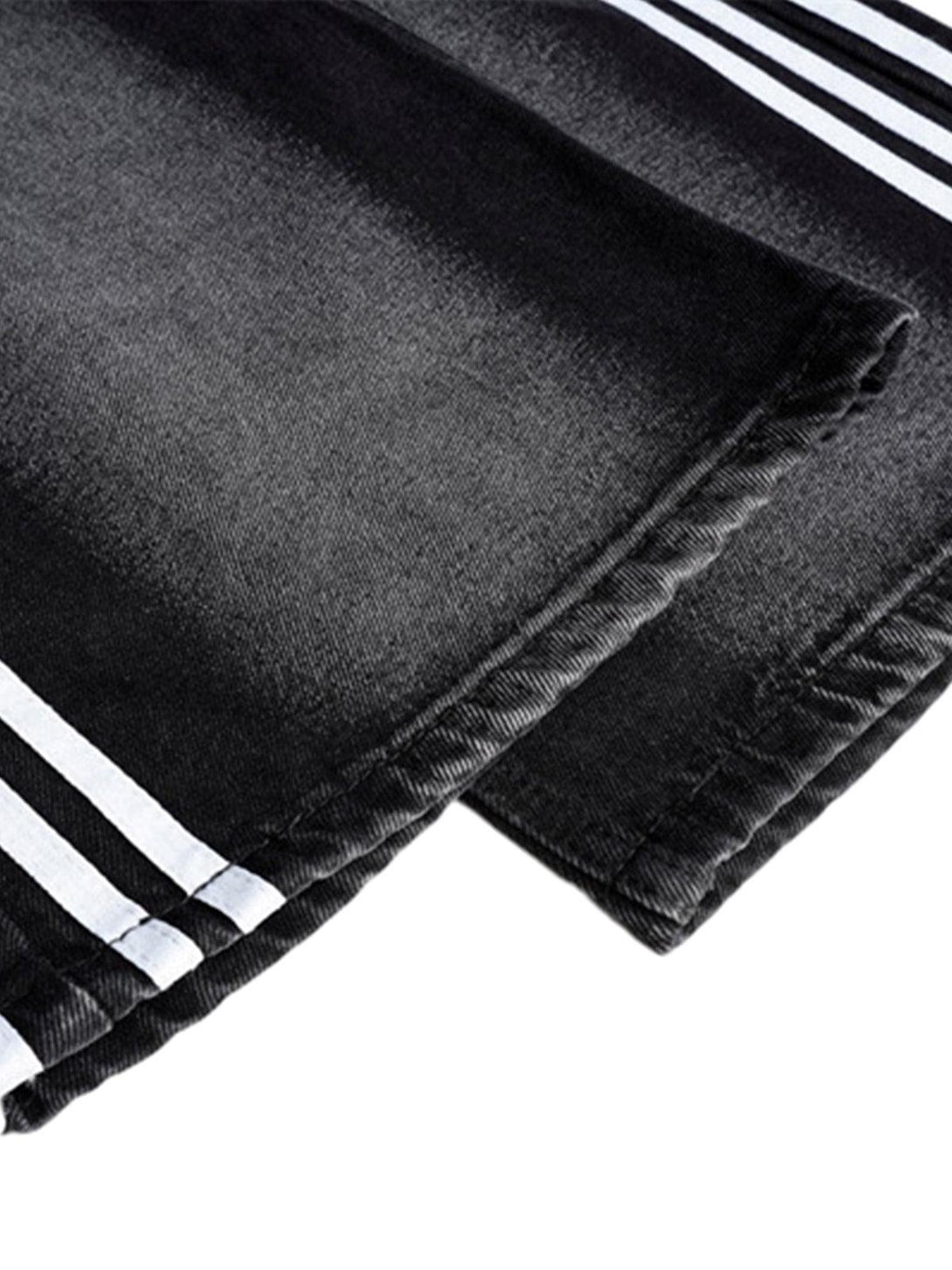 Close-up of TALISHKO street stripe paneled work jeans, highlighting the detailed stitching.
