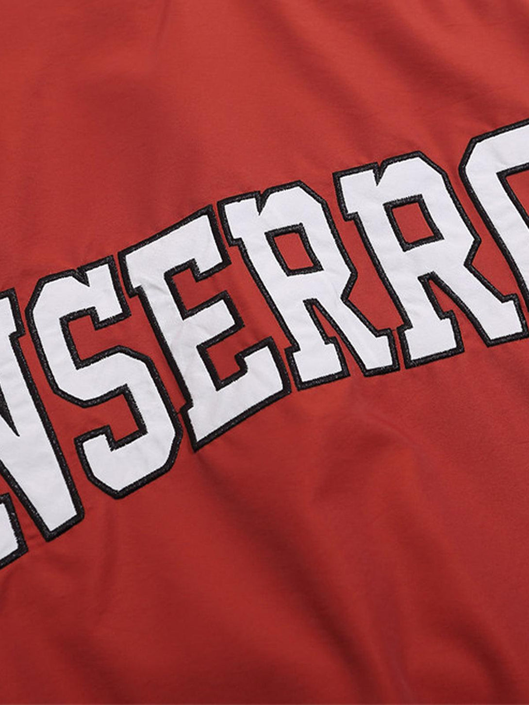 A tight crop highlighting the bold lettering on a red sweatshirt by TALISHKO.