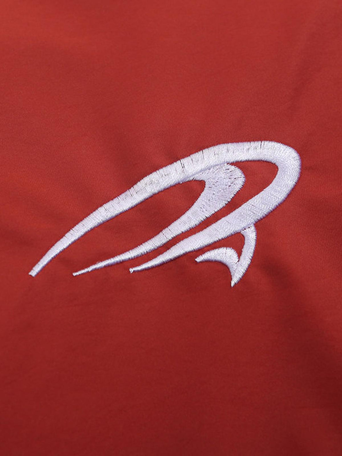Intricate embroidery detail on a red V-neck baseball-inspired sweatshirt by TALISHKO.
