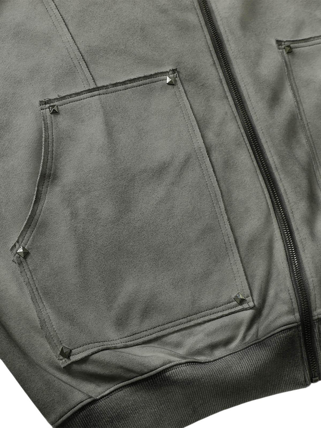 Rivet details on the pocket of a TALISHKO hooded jacket, showcasing its textured fabric.