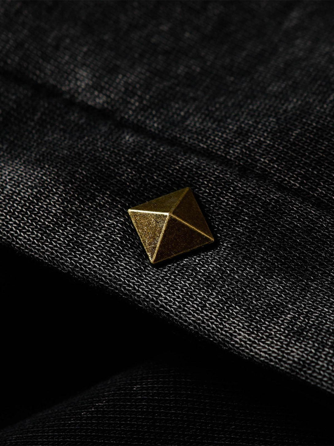 A tight crop highlighting the rivet detail on a TALISHKO hooded jacket, showcasing its texture.