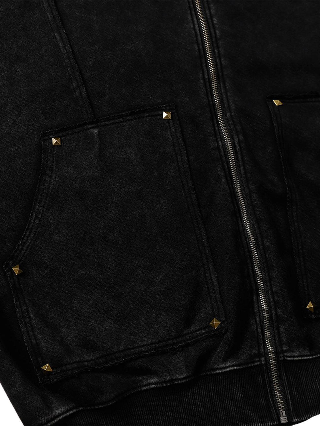 Detailed view of pocket rivet accents on a TALISHKO hooded jacket, highlighting its texture.