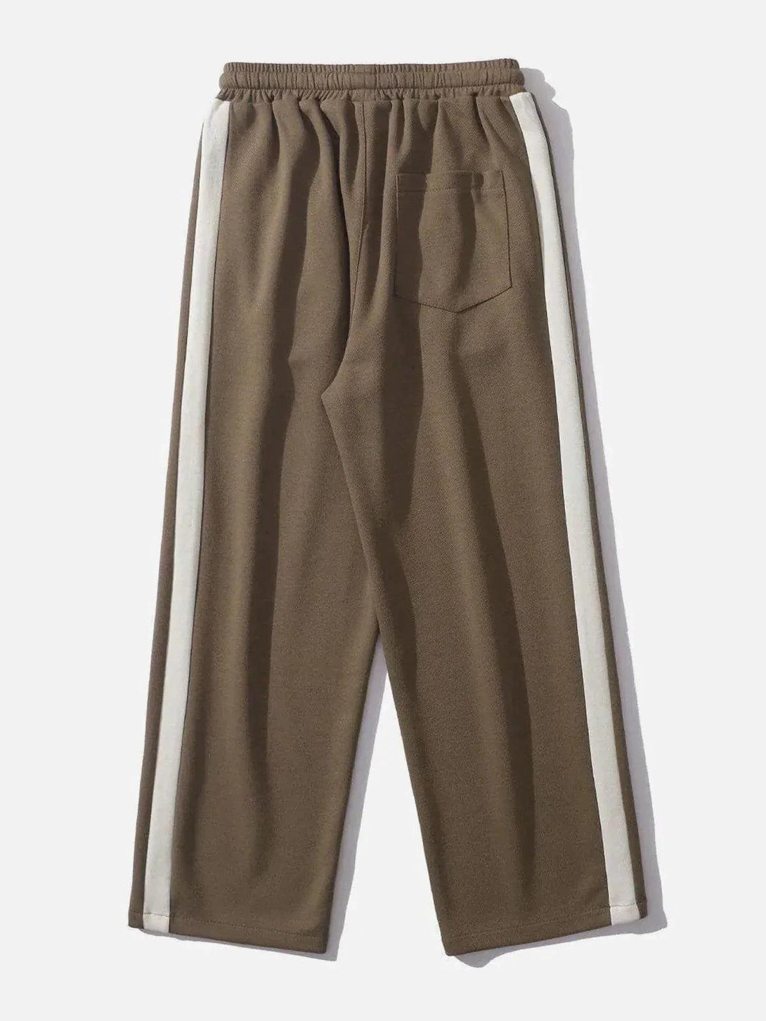 Back view of brown striped patchwork pants by TALISHKO, featuring a white side stripe.