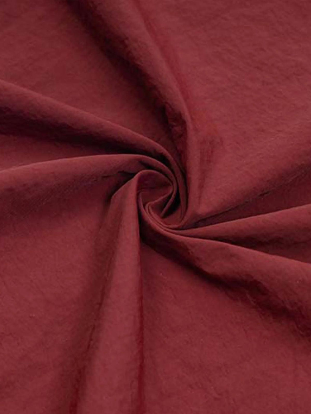 Zoomed-in texture of TALISHKO's red striped pleated fabric, emphasizing relaxed style.