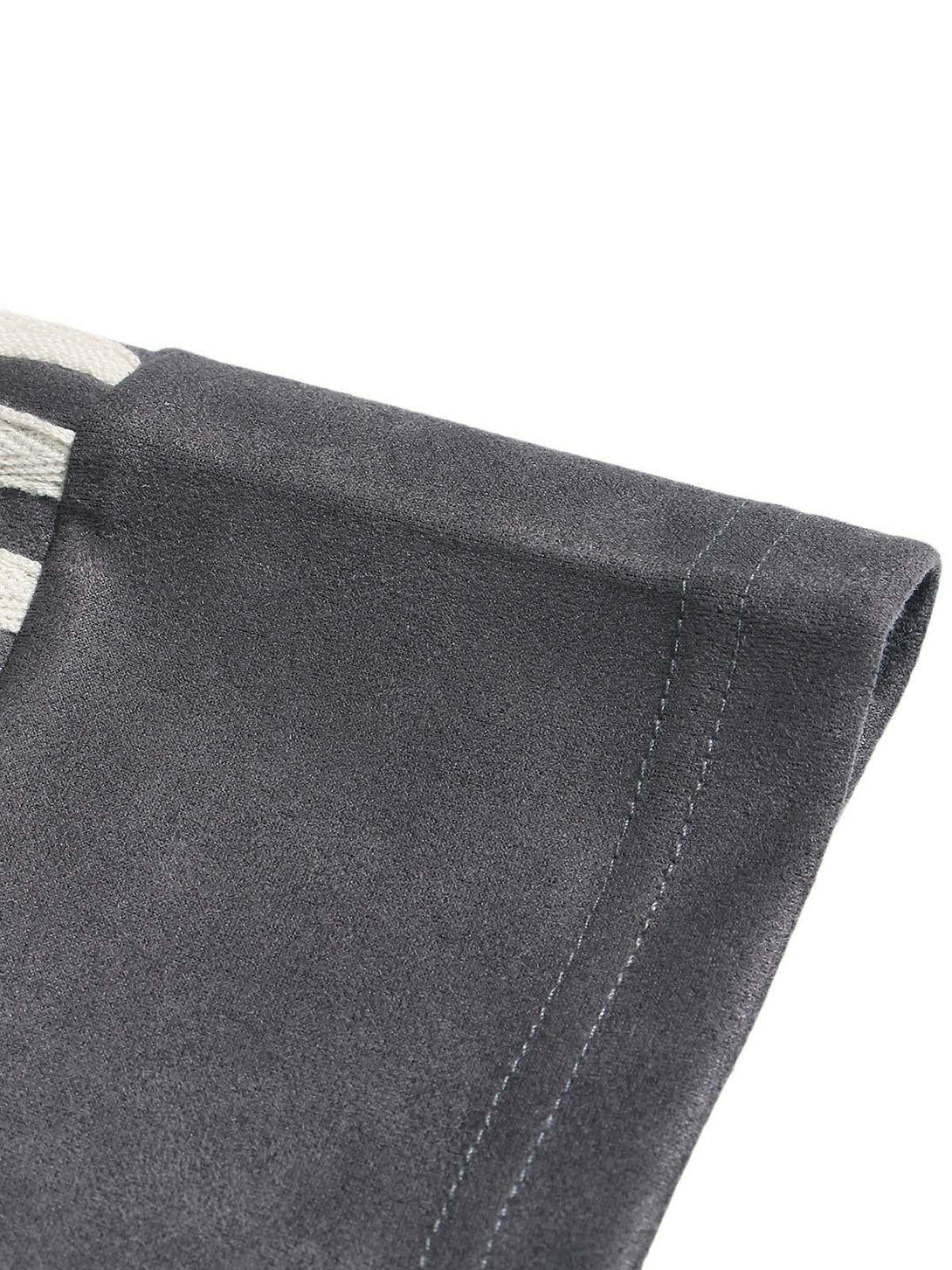 A close-up of TALISHKO's suede contrast T-shirt, highlighting the fine stitching detail.