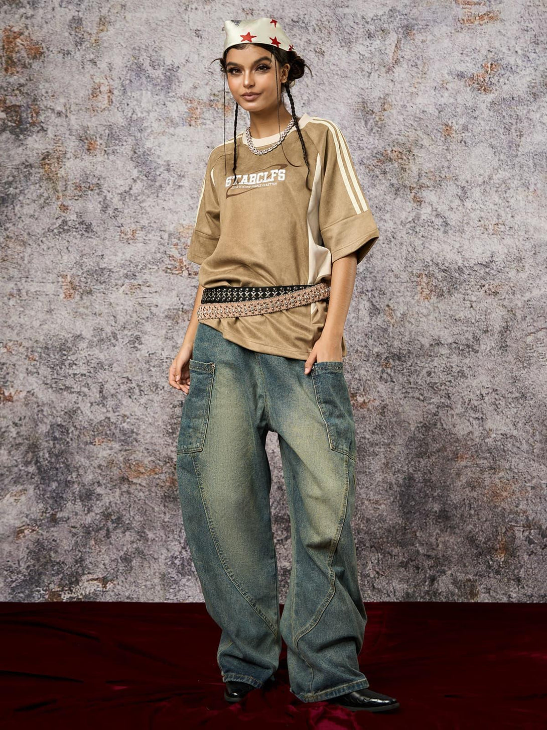 Model wearing a TALISHKO oversized T-shirt with suede contrast, paired with loose jeans and a headscarf.