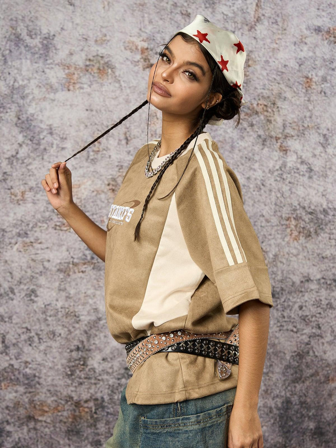 Model wearing a suede contrast oversized T-shirt by TALISHKO, styled with braids and a star-patterned headscarf.
