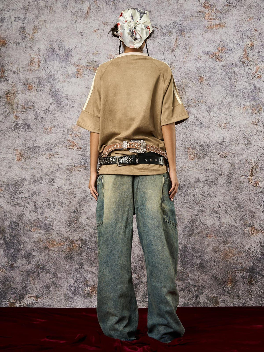 Model in a TALISHKO oversized T-shirt with suede contrast, styled with loose jeans and a headscarf.