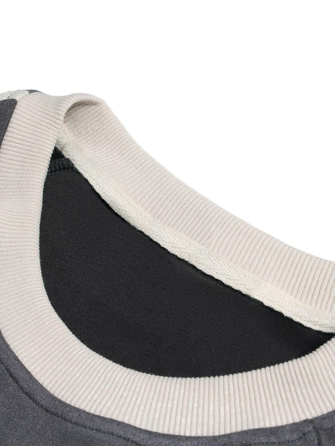 Detailed fabric and stitching of a TALISHKO oversized T-shirt, highlighting the neckline.