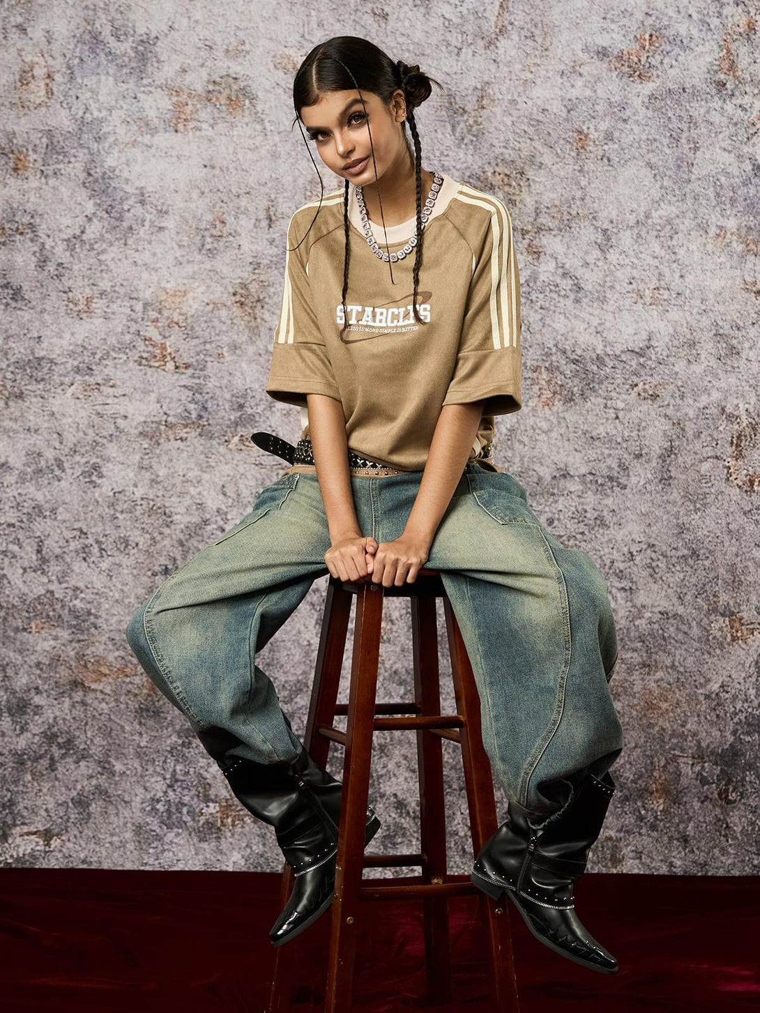 Model in a TALISHKO oversized T-shirt with suede contrast, paired with jeans and black boots.