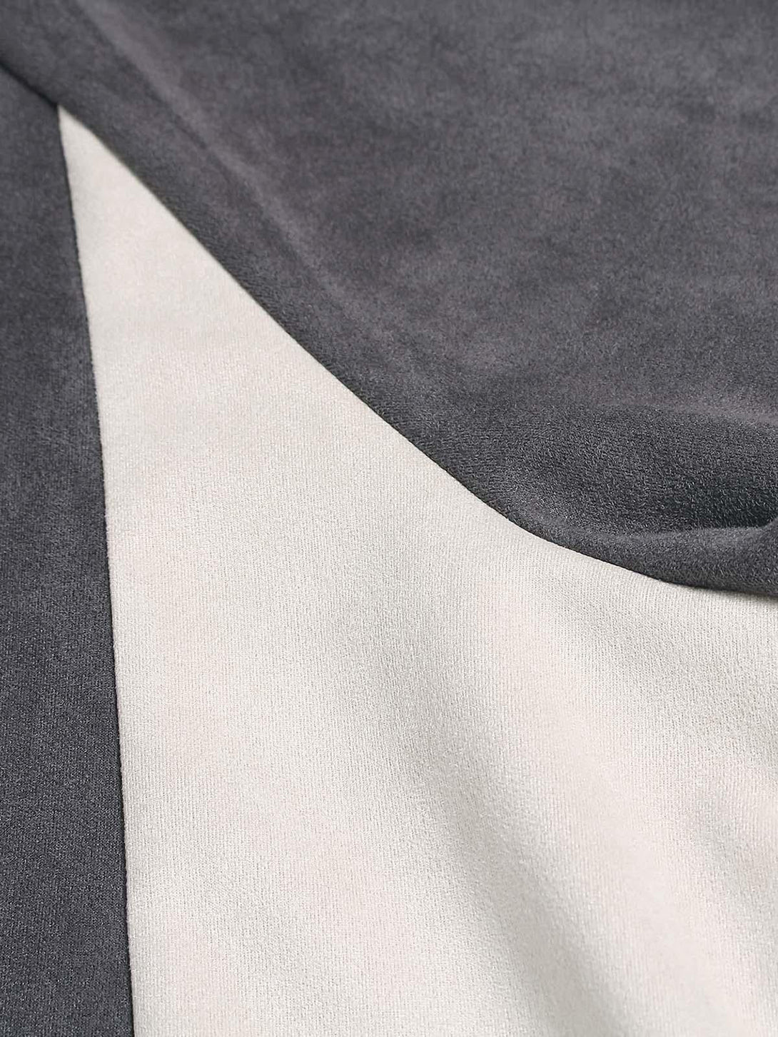 A detailed view of TALISHKO's suede contrast fabric, showcasing the soft texture and color splice.
