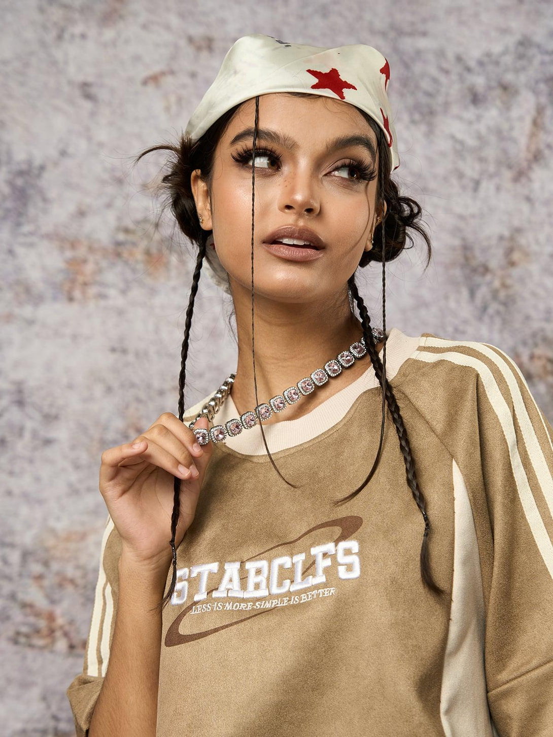 Model in a TALISHKO suede contrast oversized T-shirt, styled with a star-patterned headscarf.