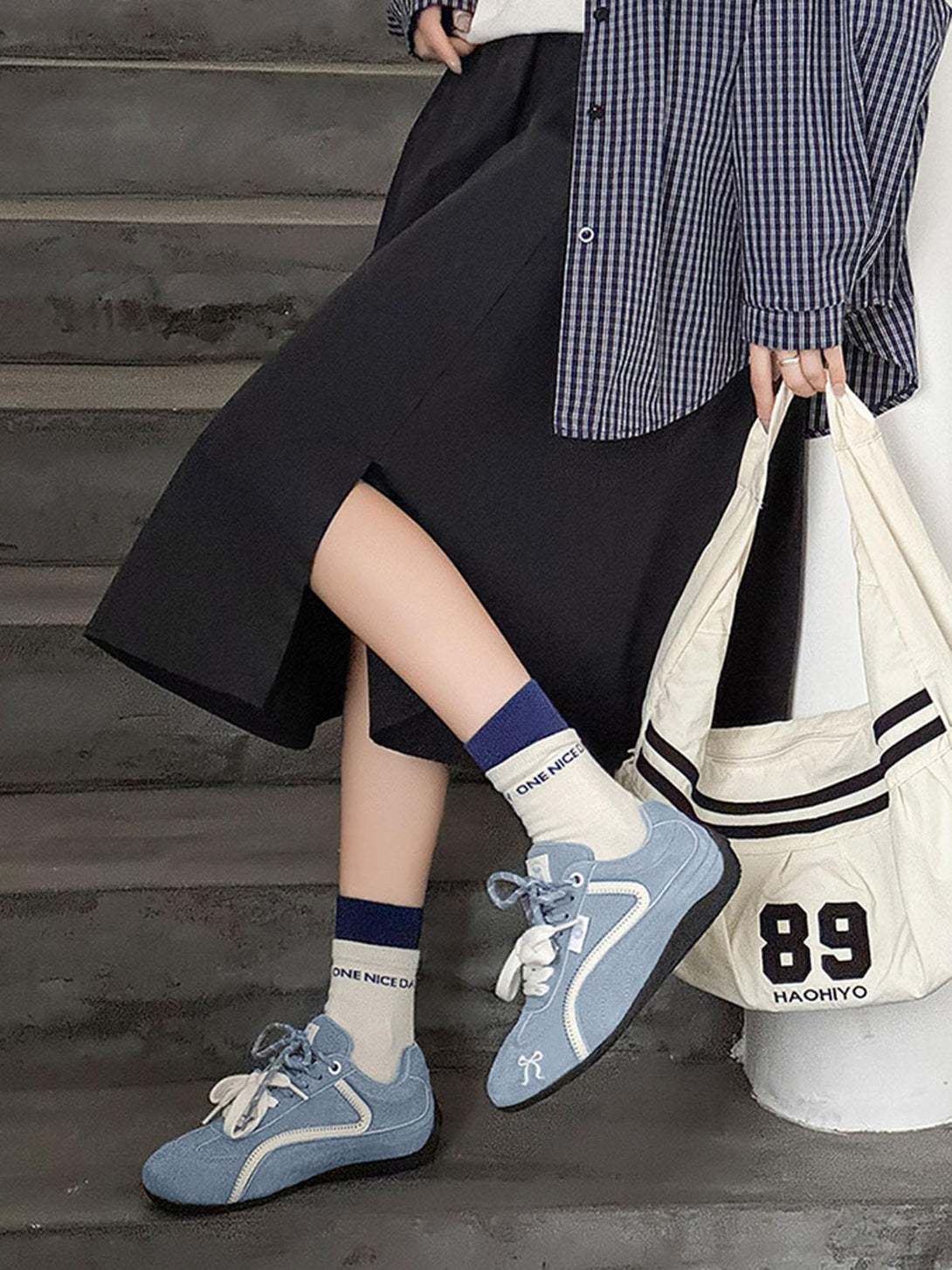 TALISHKO suede lace-up sneakers in blue paired with a chic outfit, perfect for urban style.
