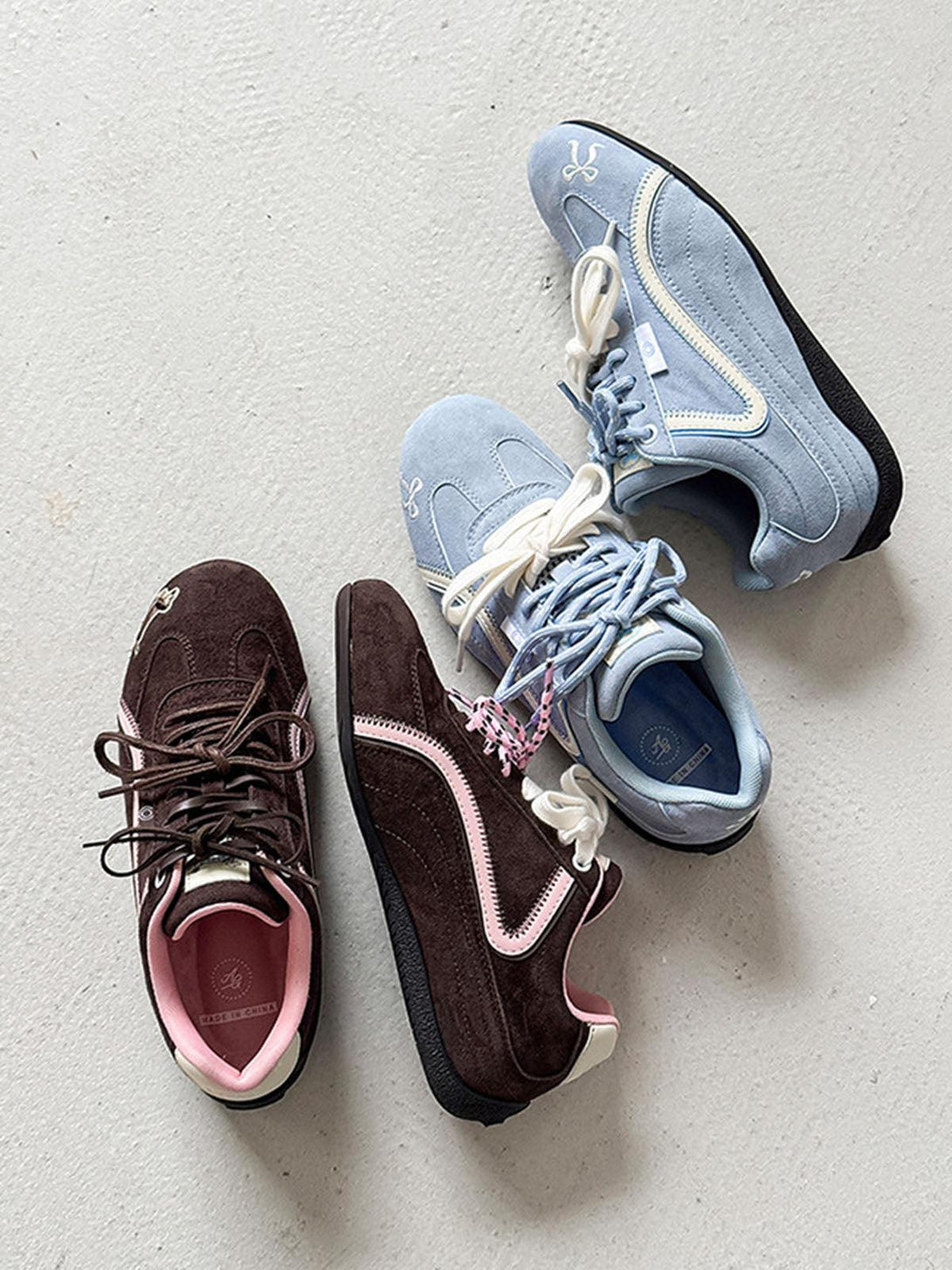 TALISHKO suede sneakers in blue and brown, showcasing unique embroidery and contrasting laces.