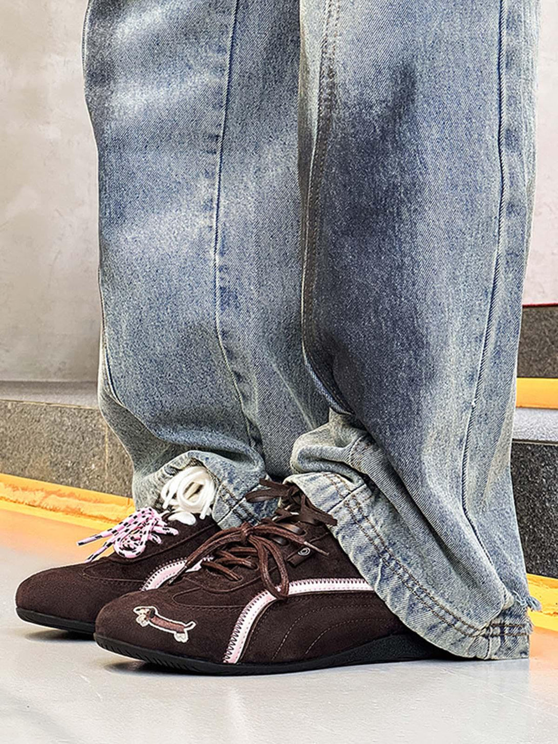 TALISHKO suede lace-up sneakers with dog embroidery, styled with relaxed denim jeans.