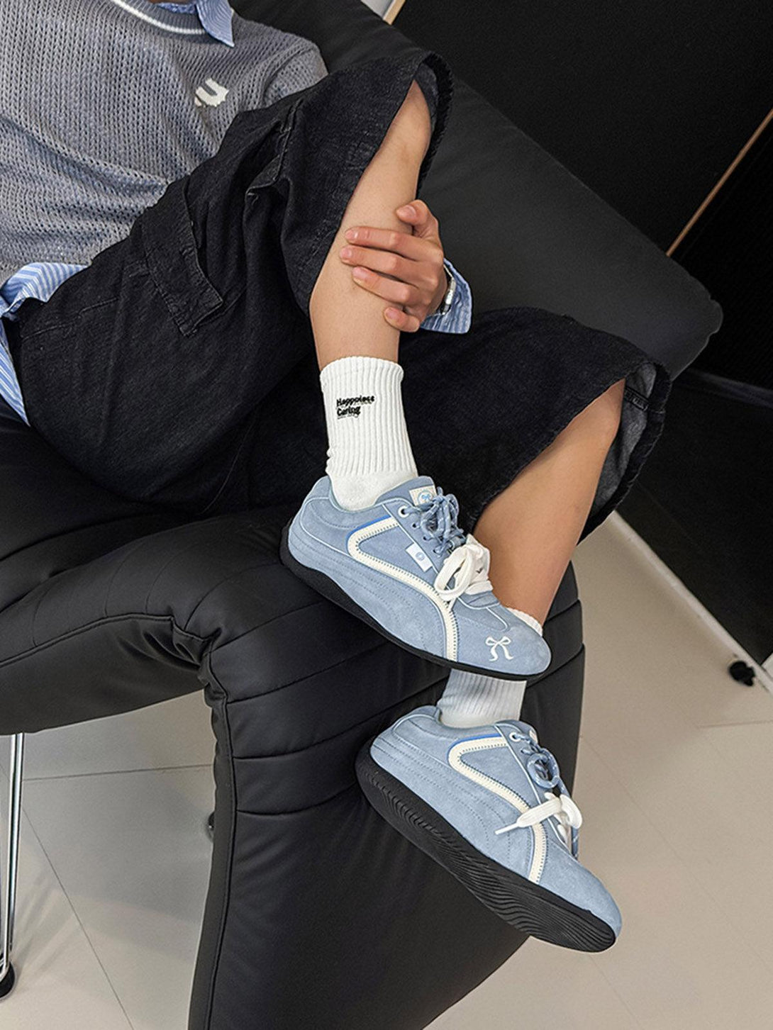 TALISHKO suede lace-up sneakers in light blue, styled with relaxed shorts for casual flair.
