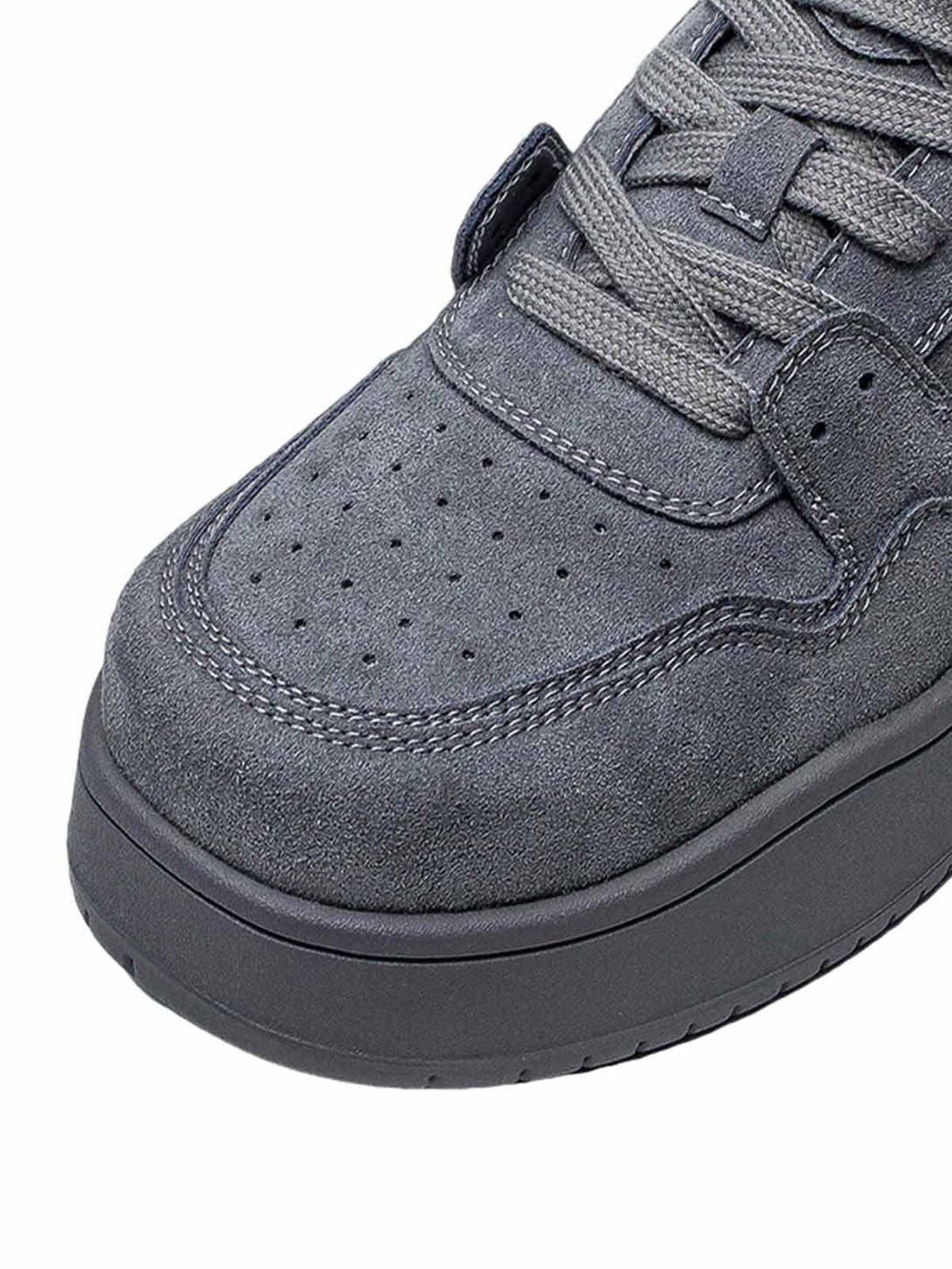 Intricate look at TALISHKO's suede skate shoes, highlighting textured stitching and laces.