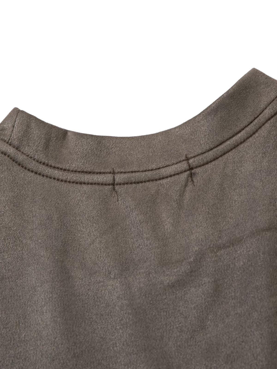 Detailed fabric and stitching on a suede vest by TALISHKO, showcasing the smooth texture.