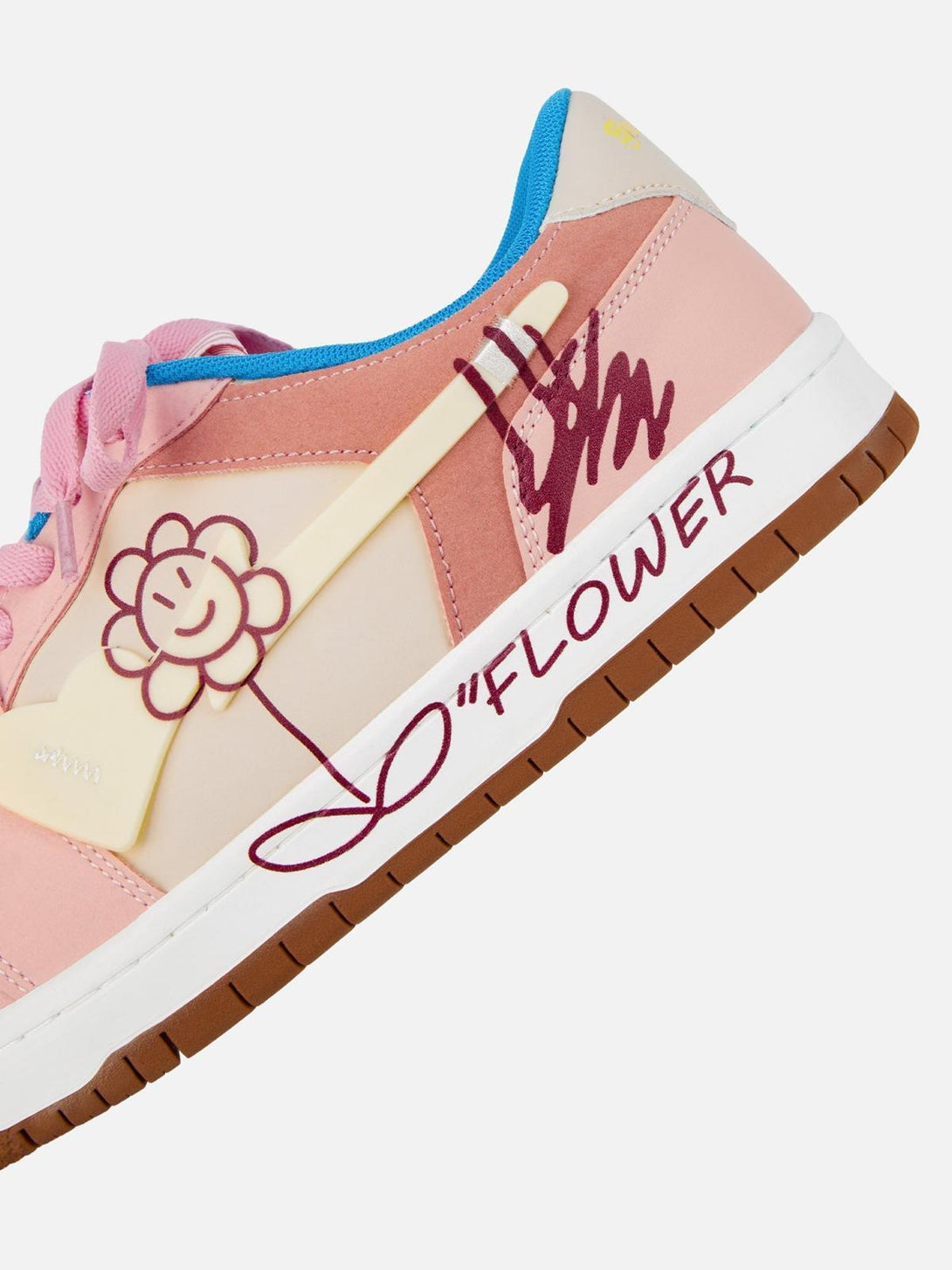 Detail of TALISHKO pink skate shoes with cheerful flower design and handwritten style accents.