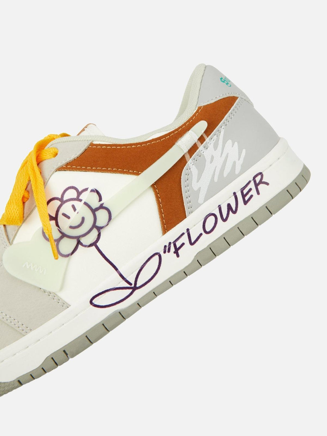 Focusing on TALISHKO skate shoe details with a playful flower graphic and orange accents.