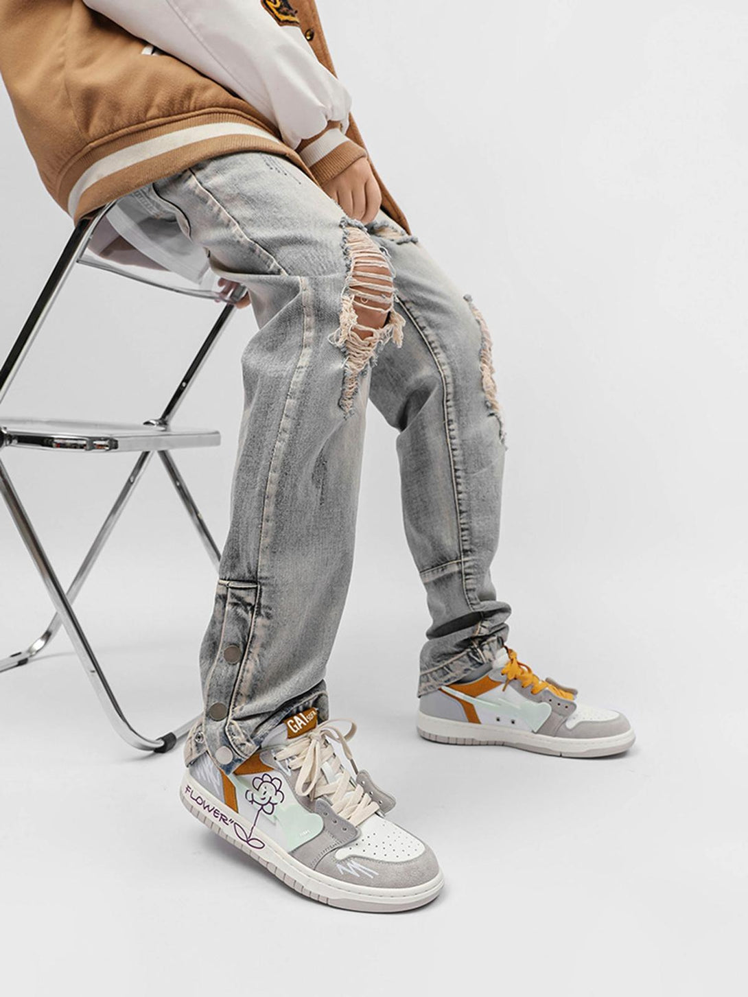 TALISHKO skate shoes with sunflower design paired with ripped jeans, highlighting urban style.