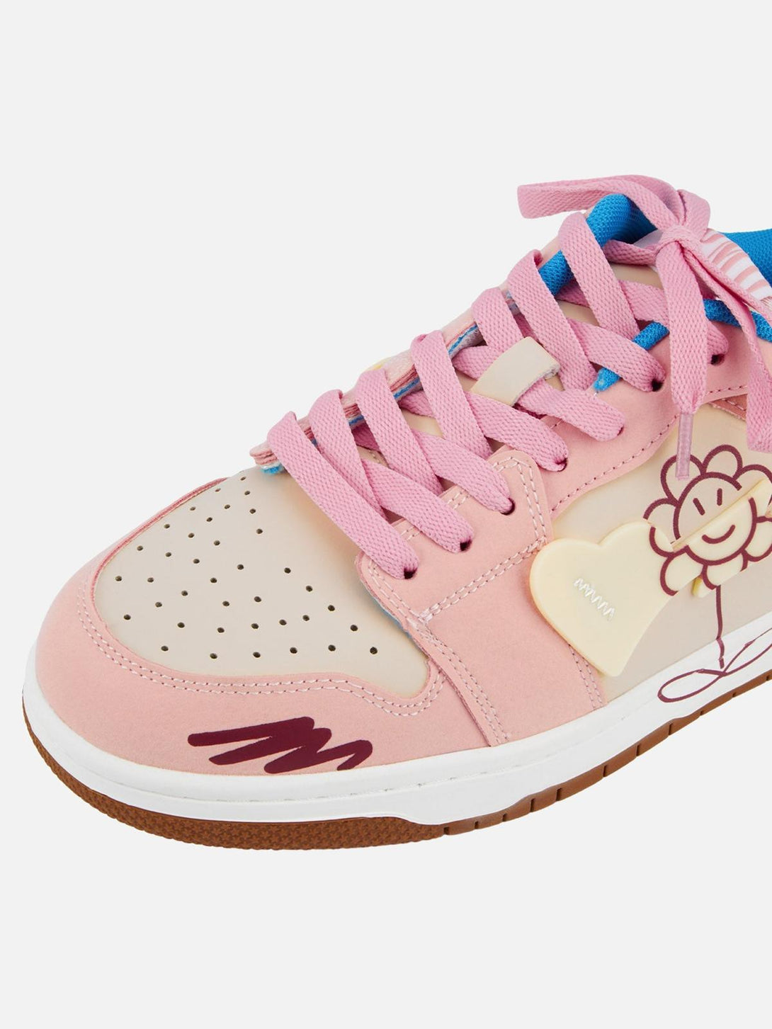 Focusing on the playful flower design and pink details of TALISHKO skate shoes.