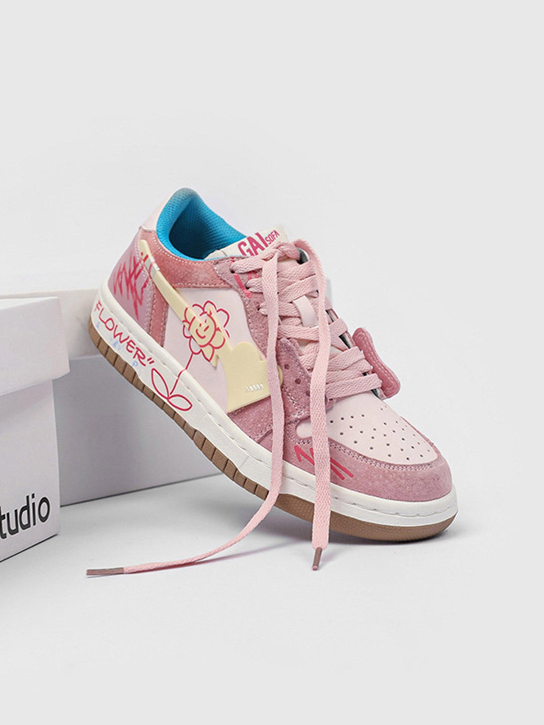 TALISHKO pink skate shoe side view, featuring cheerful flower graphics and unique design details.