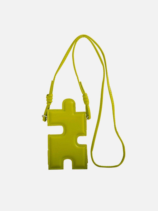 A vibrant green 3D jigsaw puzzle-shaped bag with a long strap, perfect for quirky outfits by TALISHKO.
