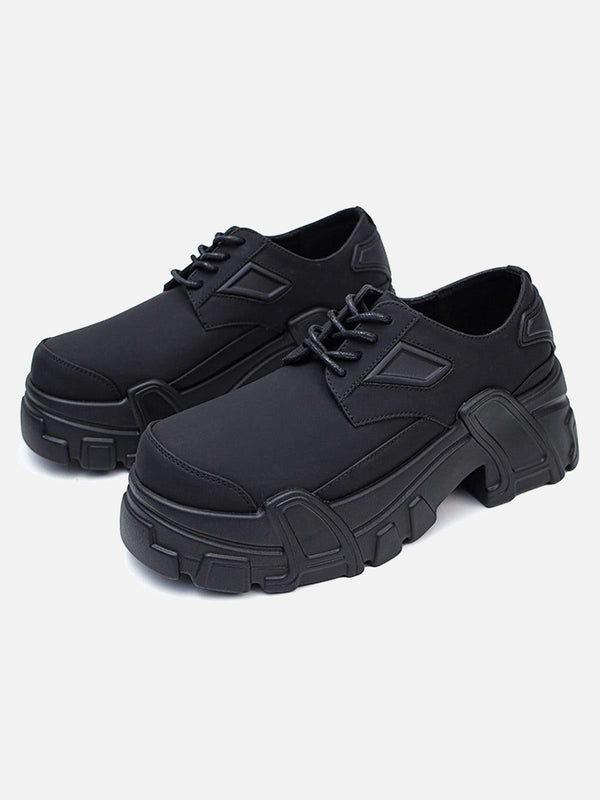 All-black platform shoes by TALISHKO with a chunky sole, showcased in a front view.