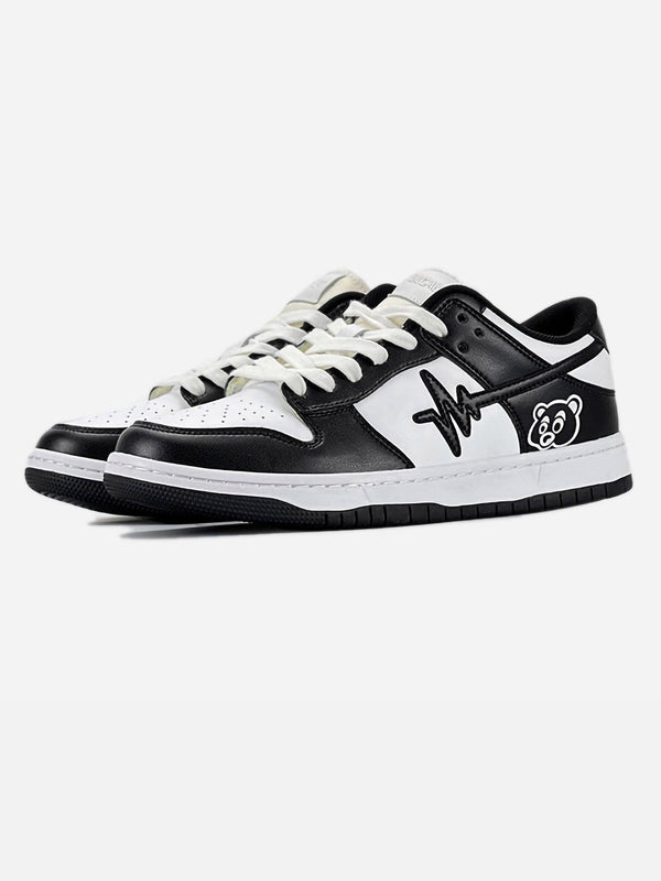 Front view of black and white American retro casual sneakers by TALISHKO with graphic details.