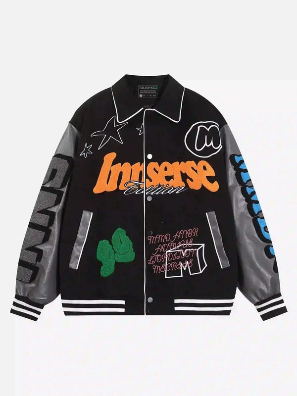 Front view of a black woolen baseball jacket by TALISHKO with vibrant graphic patches.