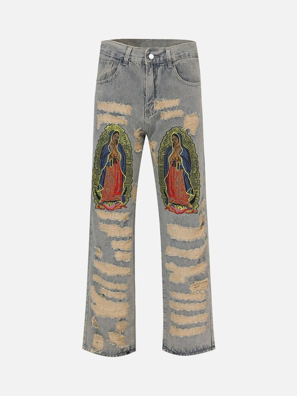 TALISHKO blue jeans featuring intricate religious patches and distressed details, front view.
