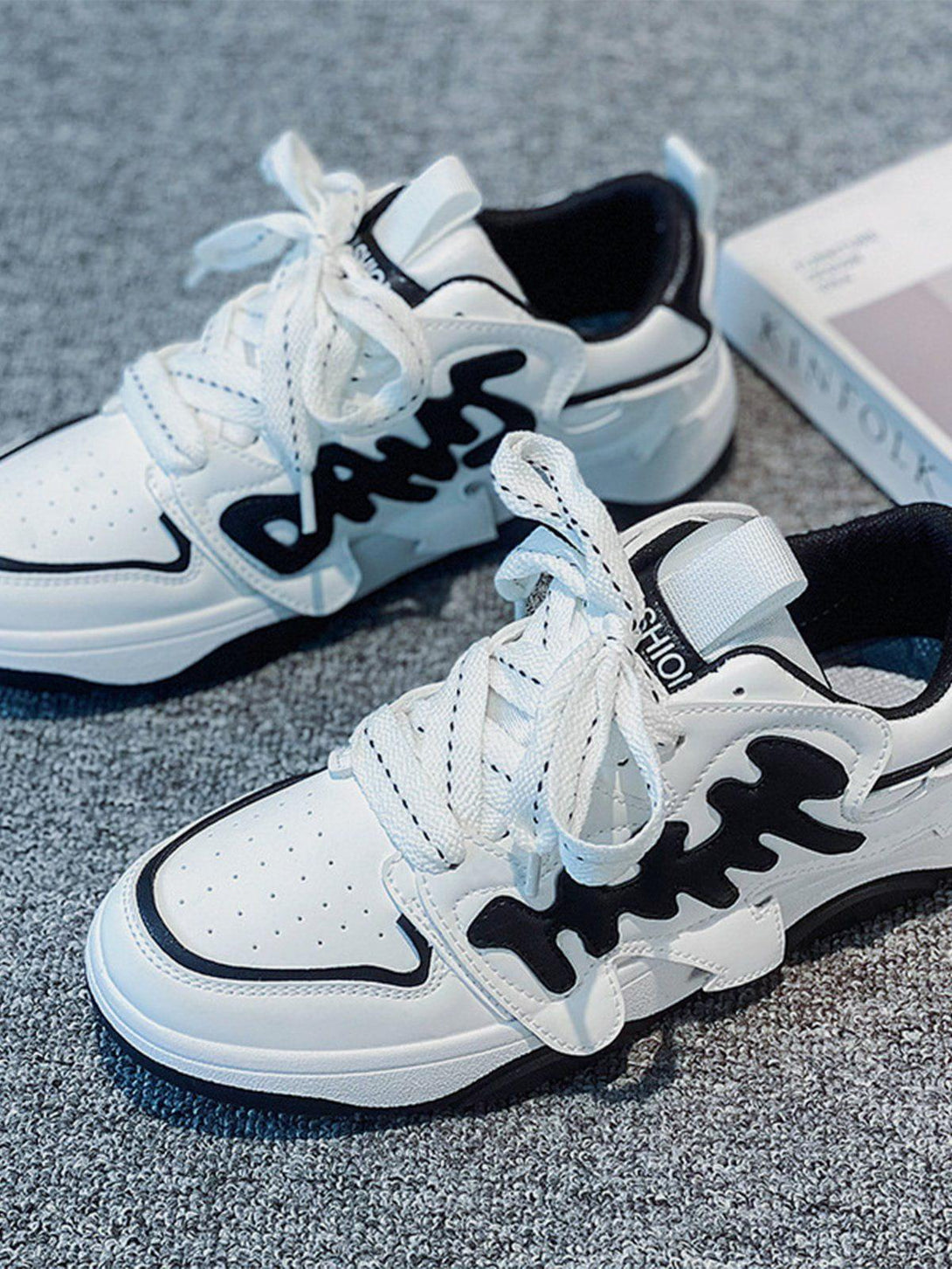 TALISHKO skate shoes in white and black with bold arrow design, perfect for casual style.