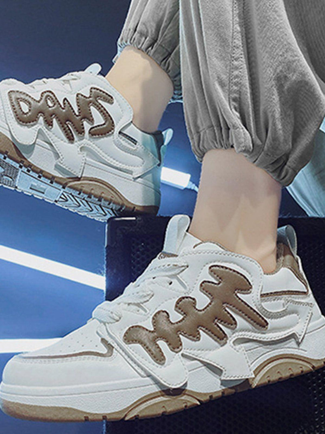 TALISHKO skate shoes in white and khaki with bold arrow details, styled for urban flair.