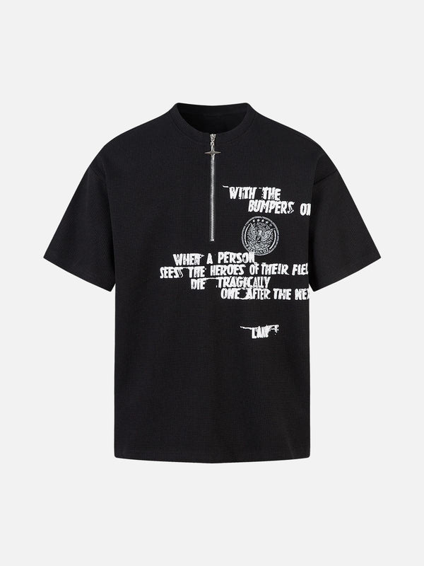 Front view of black graphic T-shirt by TALISHKO with bold white text and zipper detail.