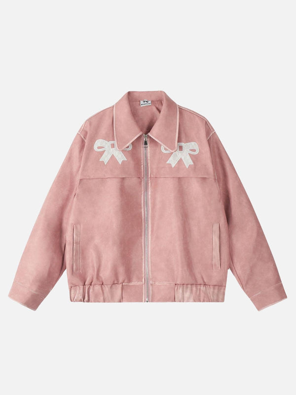 Front view of a pink faux leather jacket by TALISHKO, featuring delicate bow details.