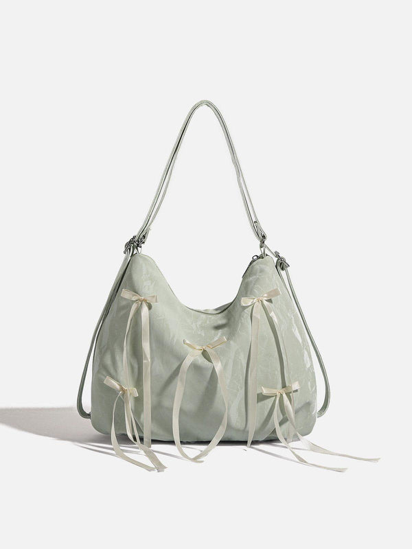 Front view of a green tote bag with bow decorations, designed by TALISHKO.