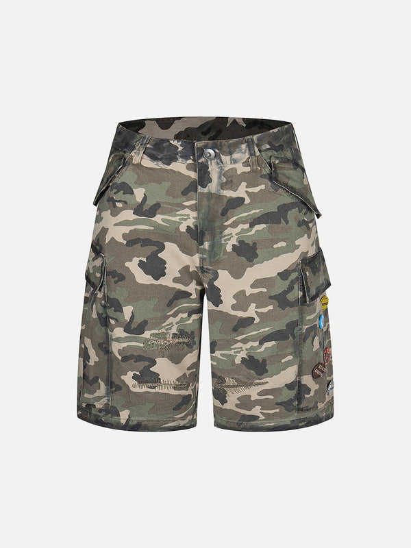 Front view of TALISHKO camouflage cargo shorts with badge details, ideal for casual outings.