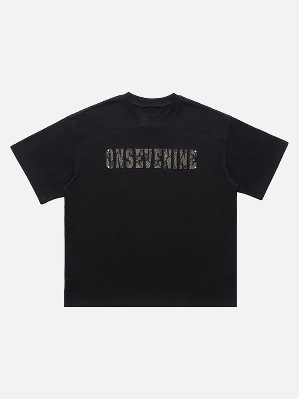 Black short sleeve T-shirt by TALISHKO featuring camouflage lettering on the front view.
